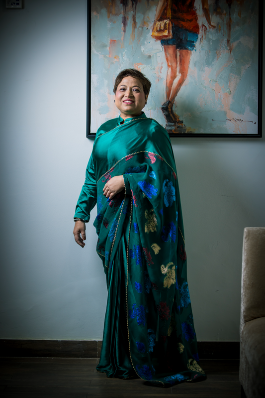 Teal saree with multicolor embroidery and golden border – festive Indian outfit for weddings and celebrations