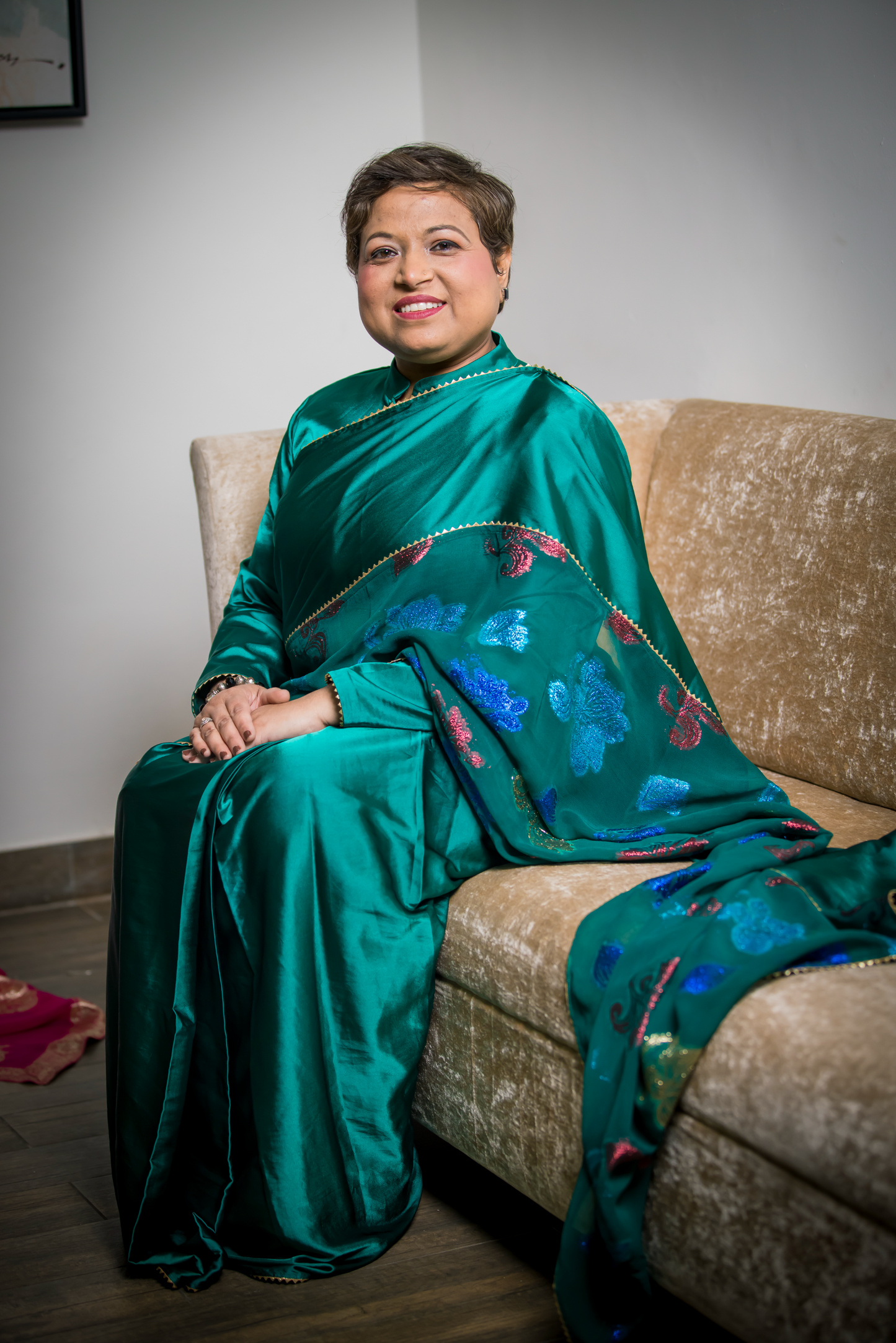 Teal saree with multicolor embroidery and golden border – festive Indian outfit for weddings and celebrations