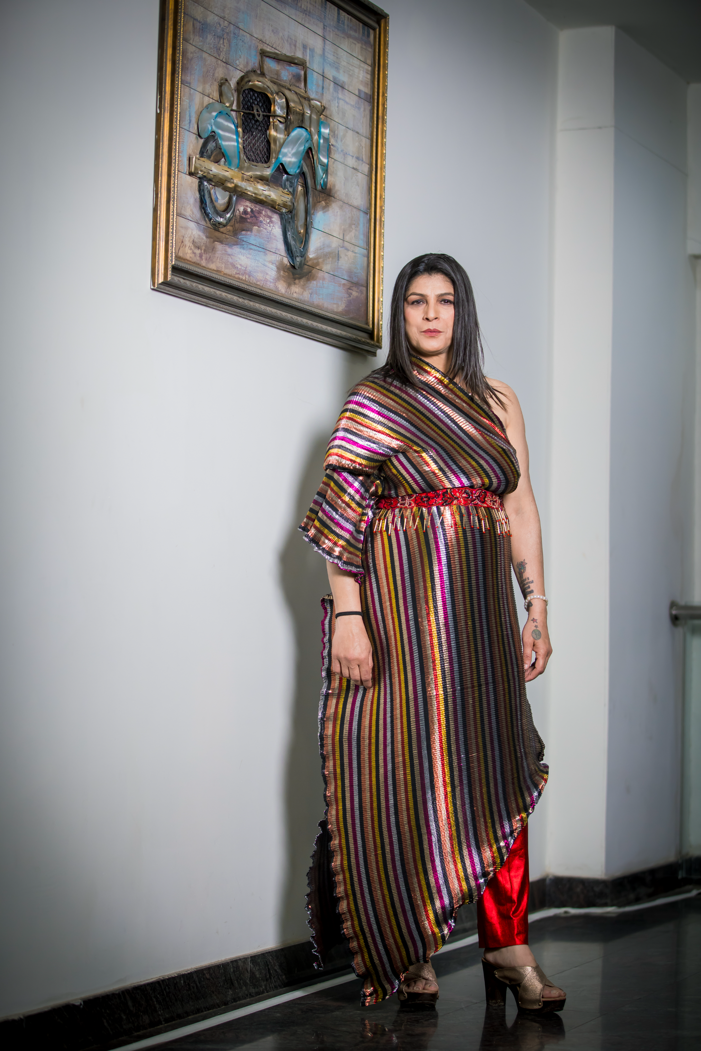 One-shoulder asymmetrical multicolored striped dress with red embroidered waist belt – bold occasion outfit