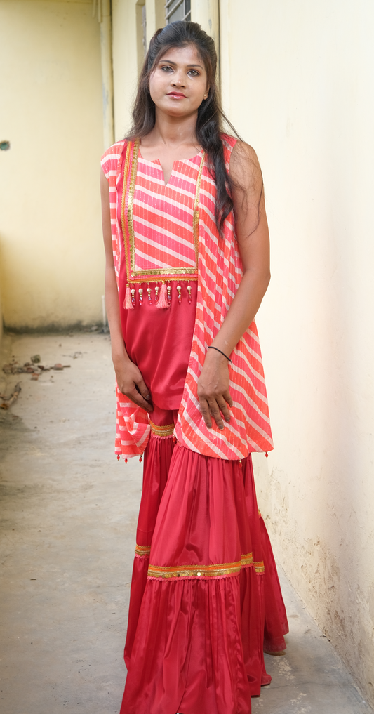 Elegant coral sharara set with gold embellishments – festive Indian outfit for women