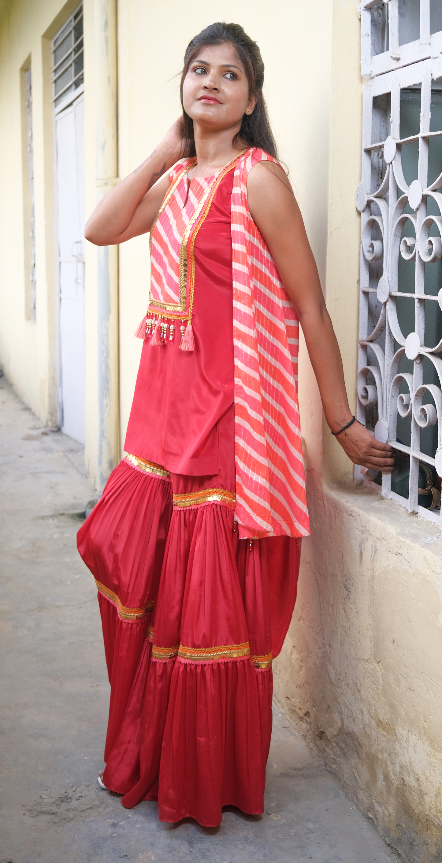 Elegant coral sharara set with gold embellishments – festive Indian outfit for women