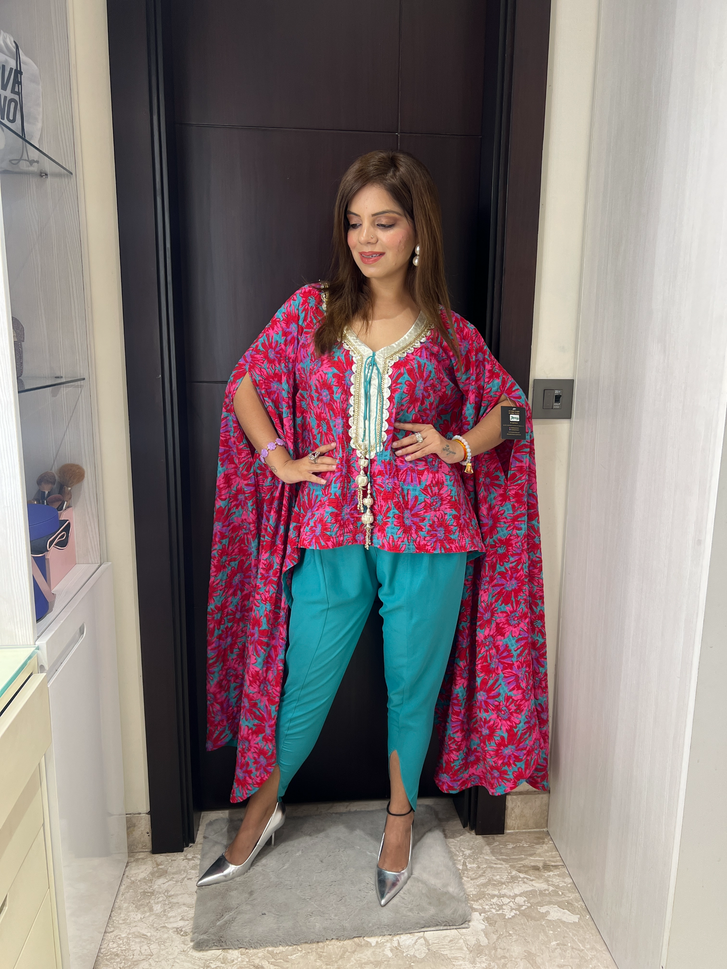 Model wearing floral cape tunic with embroidered neckline and teal cigarette pants – Indo-Western festive outfit
