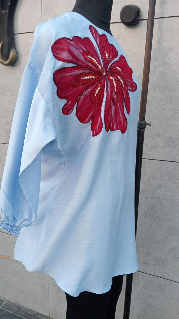 Back view of women’s oversized shirt dress with floral embroidery