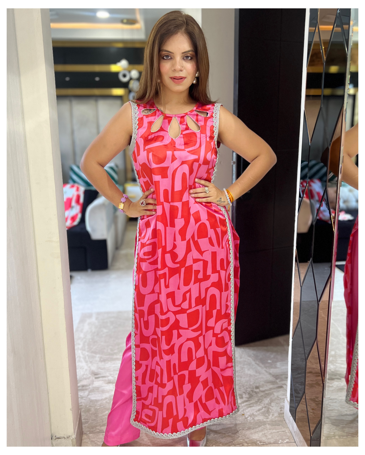 “Vibrant geometric print sleeveless kurta paired with tailored pink trousers – contemporary ethnic outfit for women”
