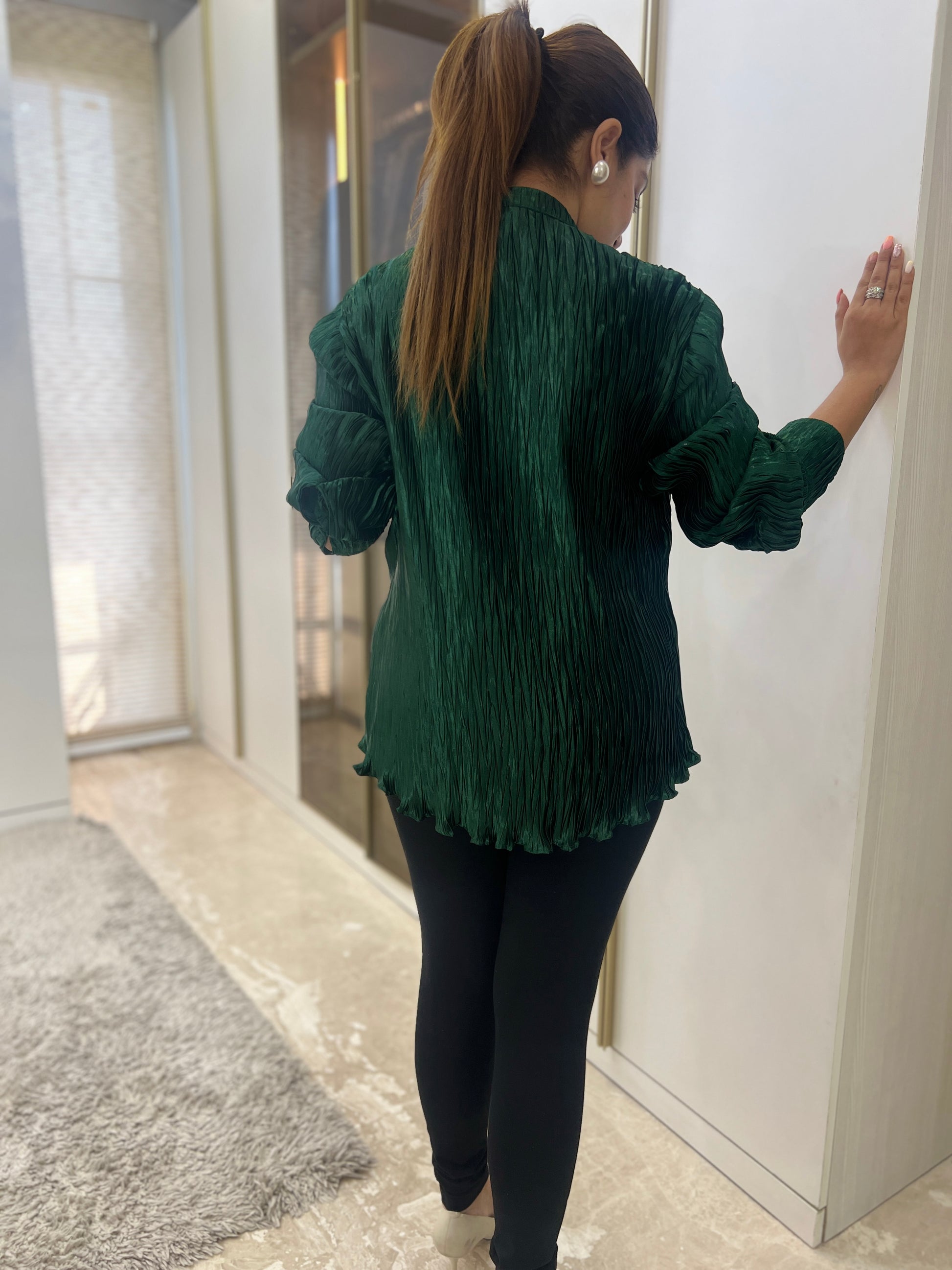 Close-up of embroidery on green women’s shirt