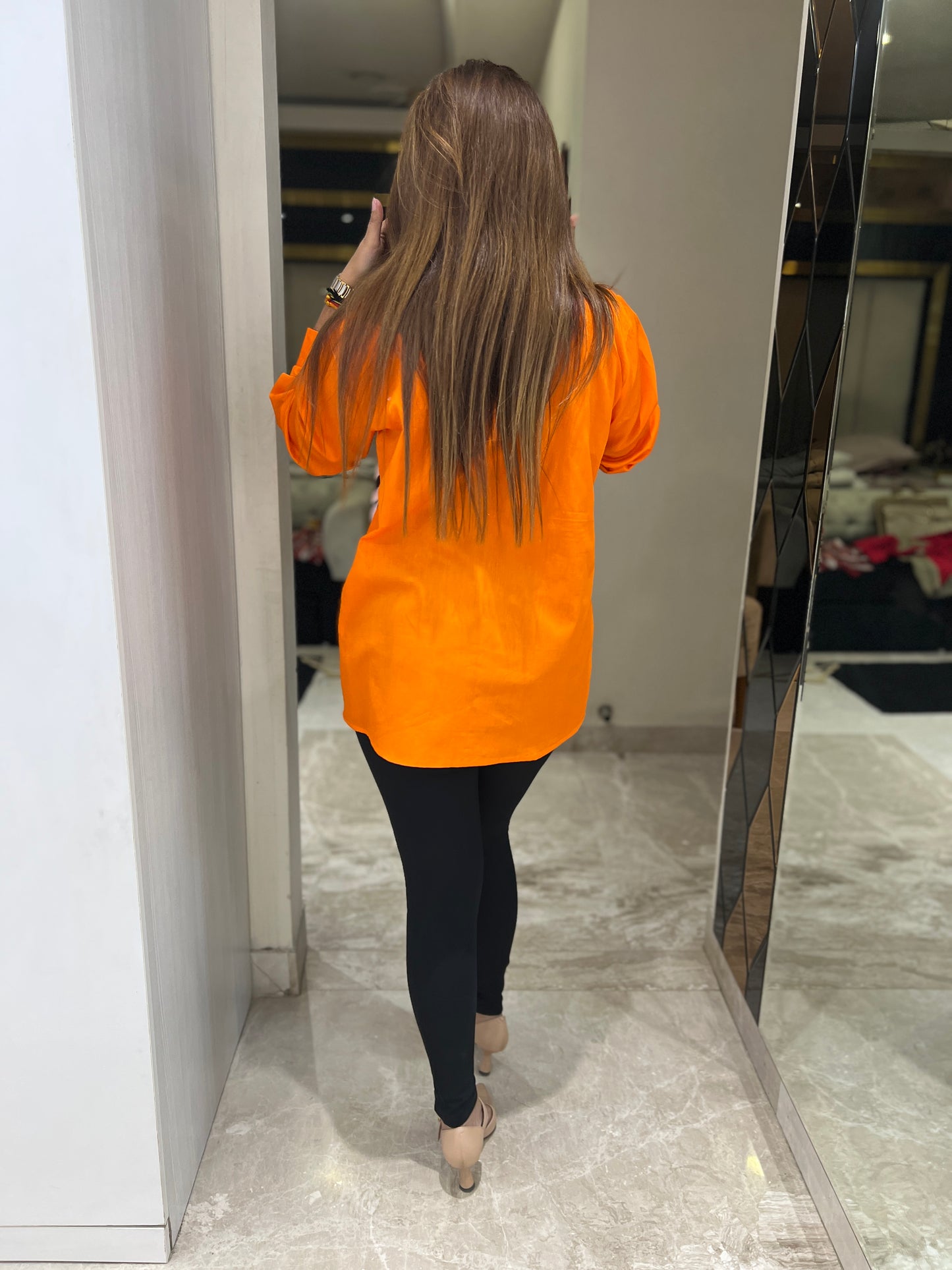 Bold orange button-up shirt for women with geometric panel design