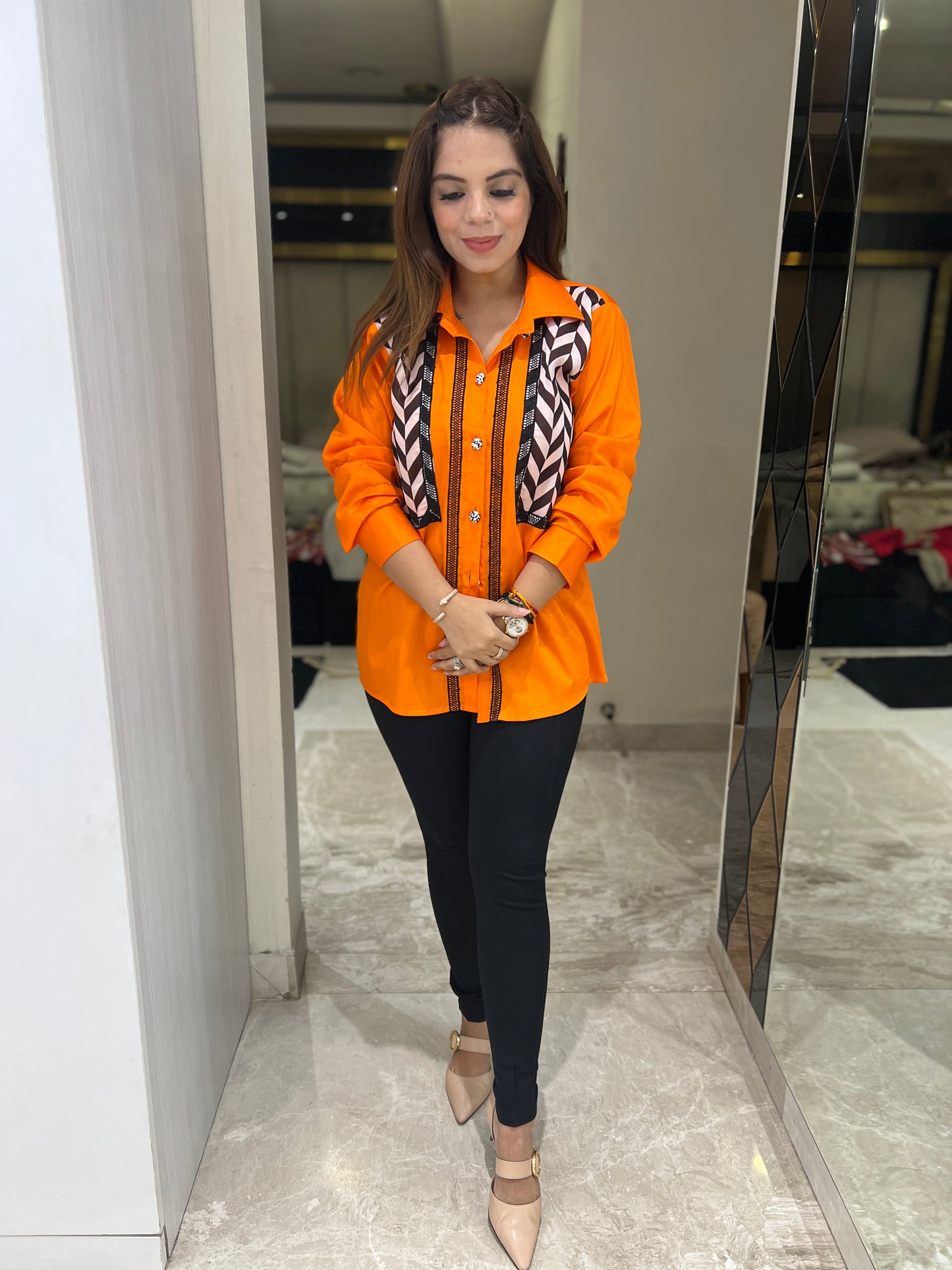 Bold orange button-up shirt for women with geometric panel design