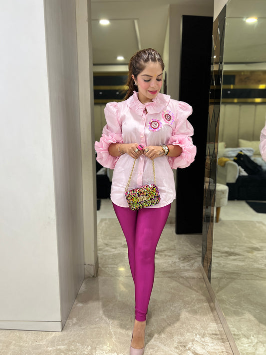 Model wearing pink ruffled puff sleeve shirt – elegant women’s fashion look