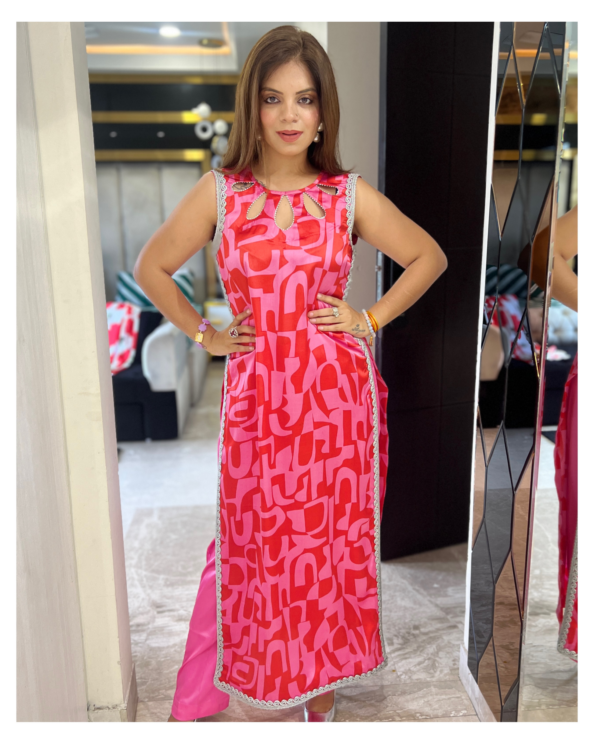 “Vibrant geometric print sleeveless kurta paired with tailored pink trousers – contemporary ethnic outfit for women

